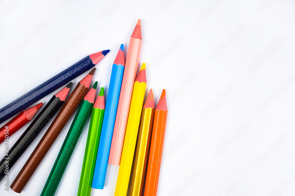 Photo of some different colored wood pencil crayon scattered on a white background Photo of some different colored wood pencil crayon scattered on a white background