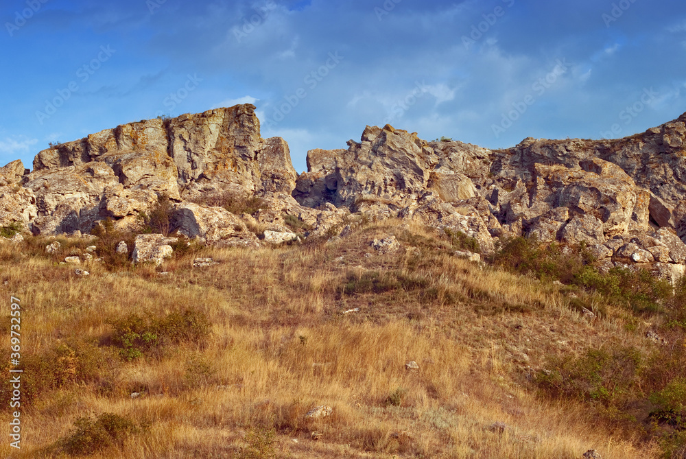 The rocks in the azov steppe at the dawn under the blue sky