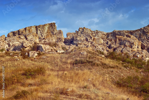 The rocks in the azov steppe at the dawn under the blue sky