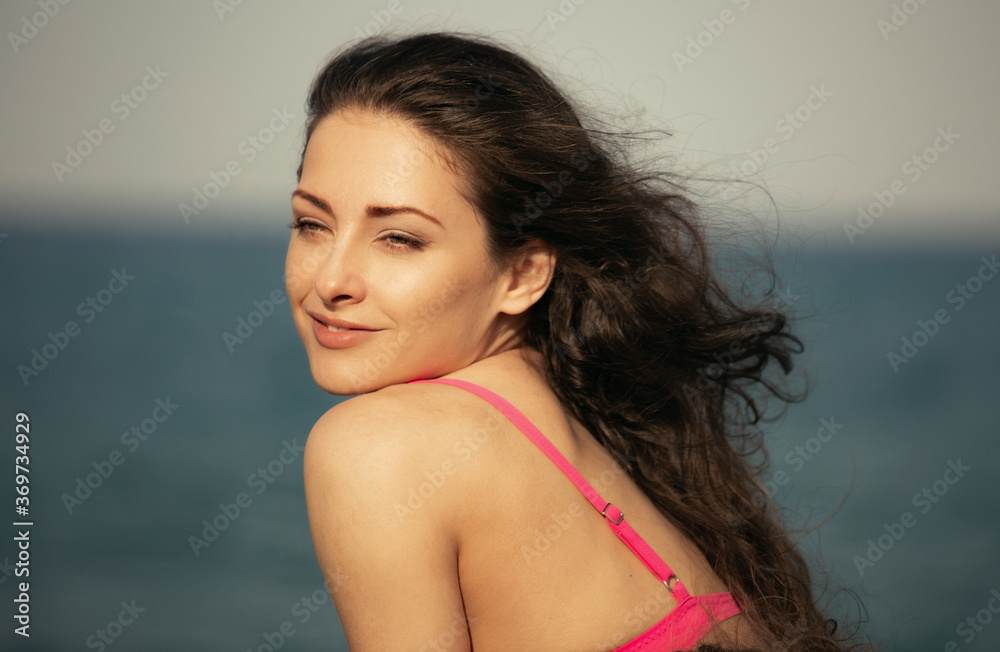 Beautiful calm thinking woman looking on the blue sea on summer holadays. Healthy face skin and long windy hair. Closeup Beautiful calm thinking woman looking on the blue sea on summer holadays. Healthy face skin and long windy hair. Closeup