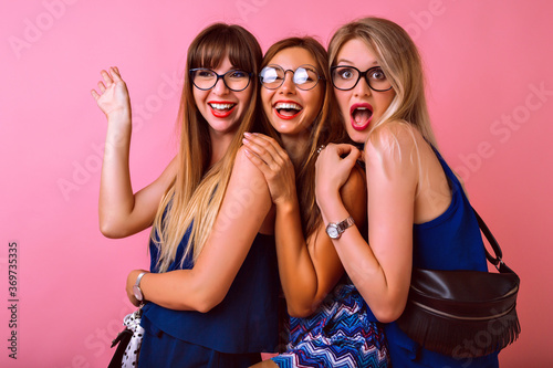 Three pretty best friends woman’s making selfie smiling and having fun at pink background, wearing color matching party navy blue clothes, students positive emotions.