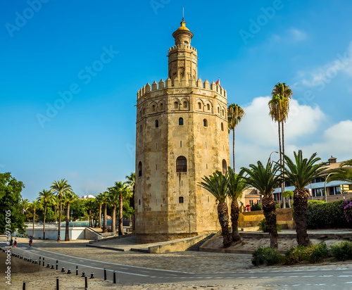 A view on the east bank of the river Guadalquivir towards the Golden Tower in Seville, Spain in the summertime