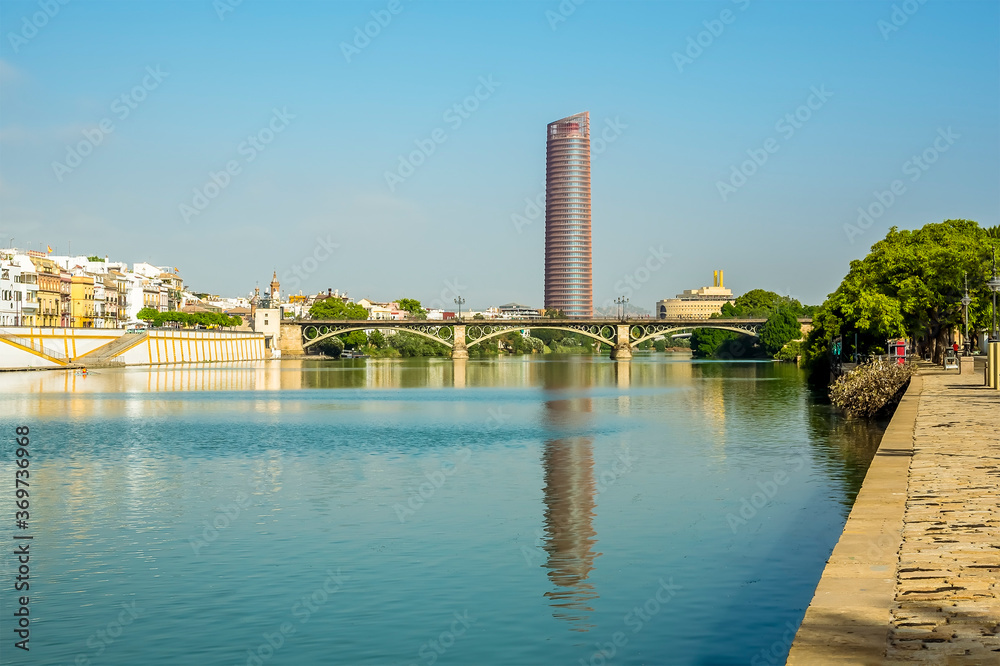 A view down the river Guadalquivir from the east bank in Seville, Spain in the summertime