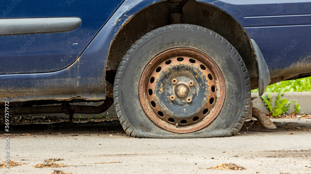 flat tire of a blue car