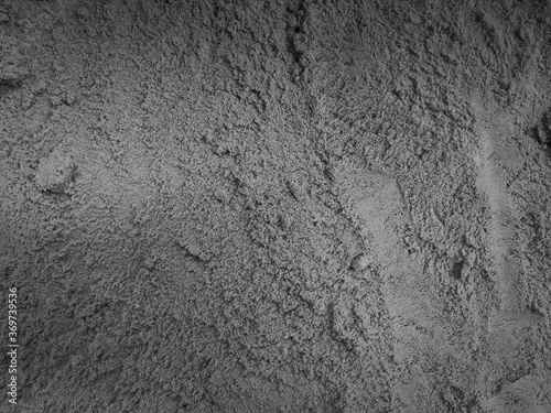 Gray sand texture, concrete-like color, rough surface background.