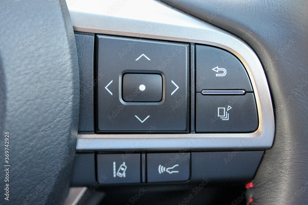 Driver aid buttons on a new vehicle steering wheel Driver aid buttons on a new vehicle steering wheel