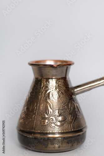 Cezve. copper turk for coffee on a light background on the stove. close-up