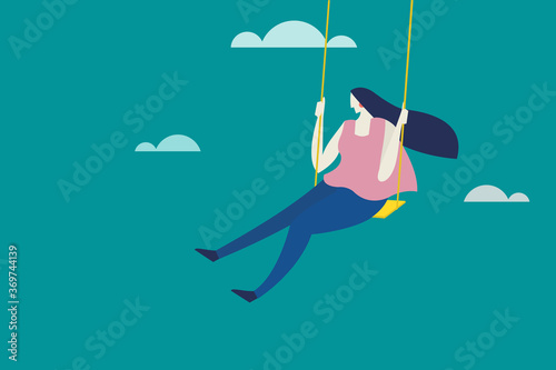 A girl swinging in a swing against a cloud background