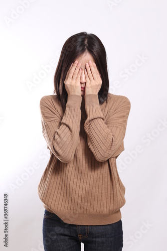 The Asian woman standing on the white background.