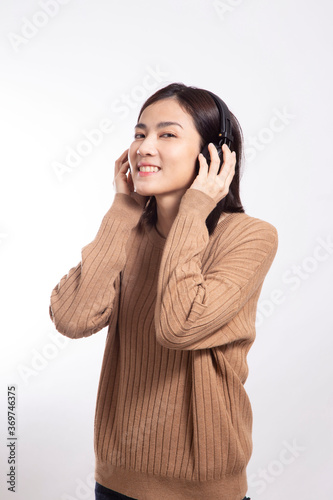The Asian woman standing on the white background.