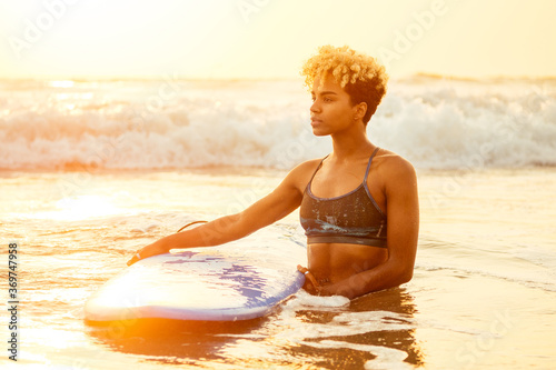 Photography african american surfer girl in water enjoying sunset