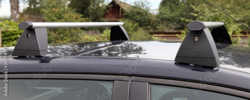 Bild auf Leinwand Top transversal aluminum aerodynamic railsings with a locks on the roof of a pas