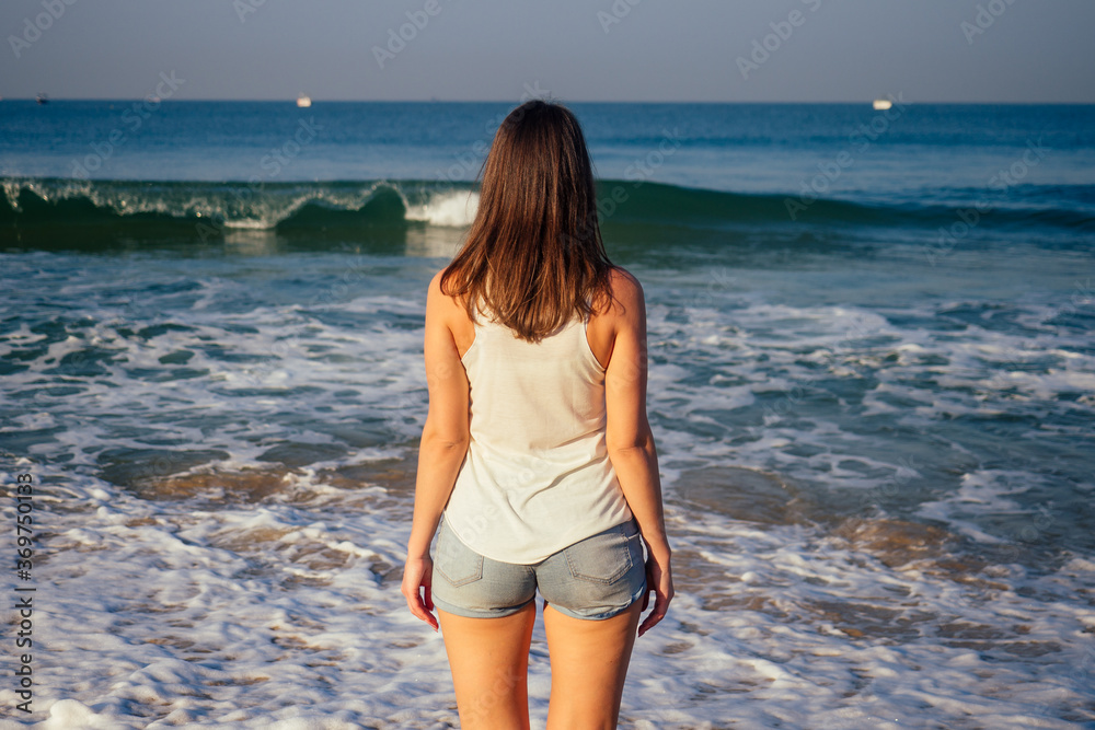 Outdoor young pretty woman posing near the sea alone Outdoor young pretty woman posing near the sea alone