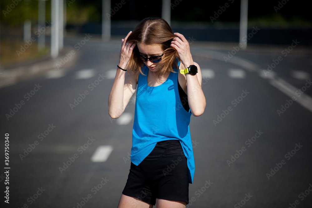 young athletic woman with short hair doing sports warm-up before jogging workout
