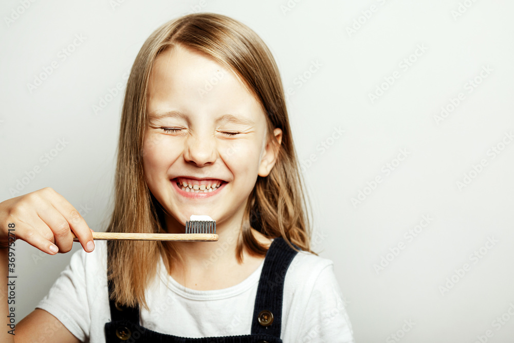 A child with a toothbrush in his hands, the child's habit of brushing teeth in the morning and in the evening A child with a toothbrush in his hands, the child's habit of brushing teeth in the morning and in the evening