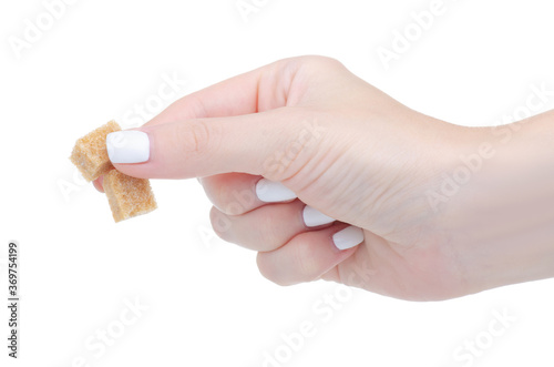 cane brown sugar cubes in hand on white background isolation