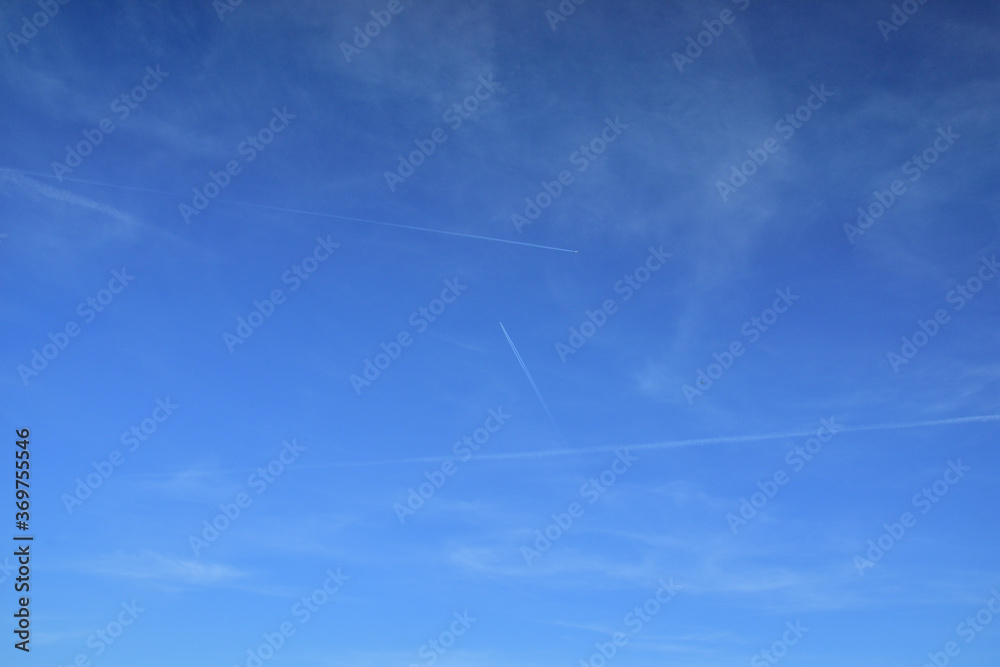 Clouds and traces of airplanes in the blue sky. Clouds and traces of airplanes in the blue sky.