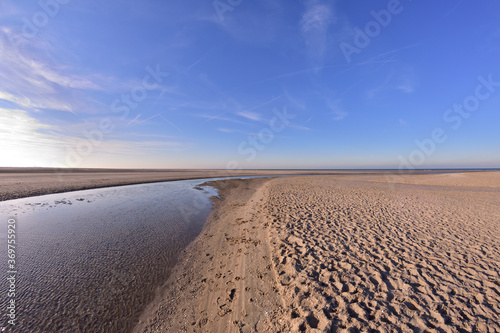 The beach and the sea coast on a sunny day in the fisheye lens.