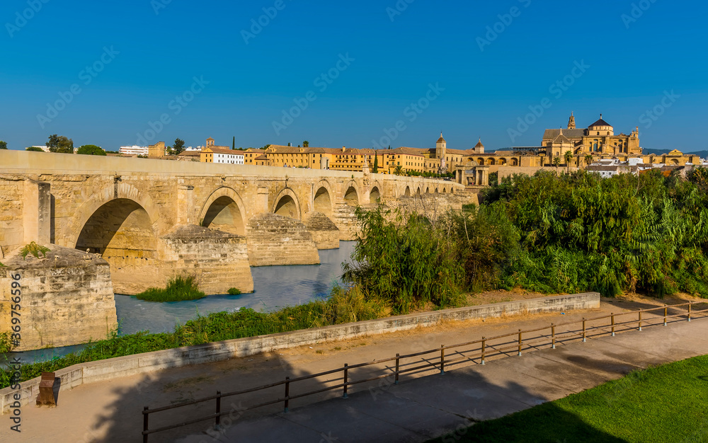 A view across the Roman bridge leading into the ancient city of Cordoba, Spain in the summertime