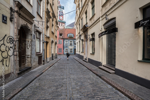 Picturesque street in Old Town of Riga  colorful  well preserved   historic buildings   cobble stones paved and winding narrow street  Riga  Latvia.