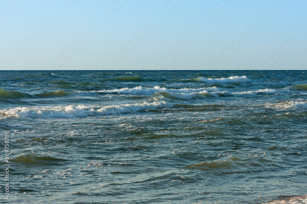 late evening at the Baltic Sea, the sun reflects on the waves late evening at the Baltic Sea, the sun reflects on the waves