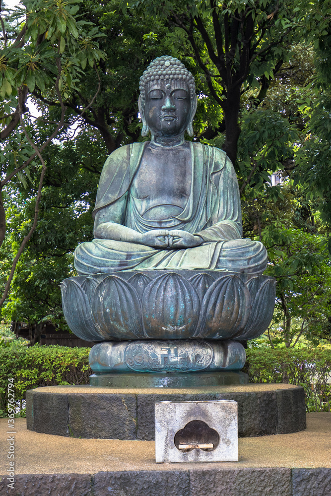 Statue of the meditating Buddha sitting in the lotus position, Senso-ji Buddhist temple, Tokyo, Japan