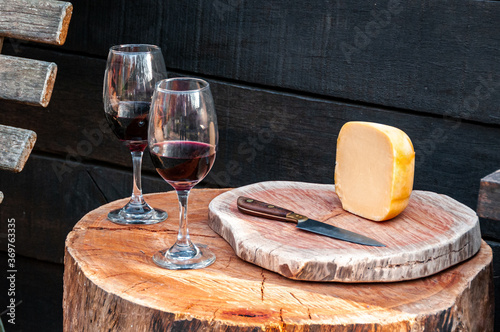 Glass of whine and chease on wooden table  photo
