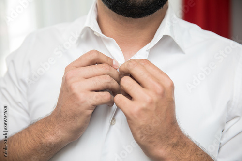 man hand in shirt button