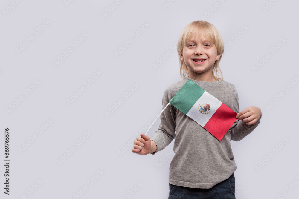 Exciting Fair-haired boy holding flag of Mexico on white background. Exciting Fair-haired boy holding flag of Mexico on white background.