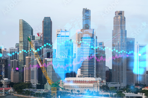 Forex and stock market chart hologram over panorama city view of Singapore, the financial center in Asia. The concept of international trading. Double exposure.