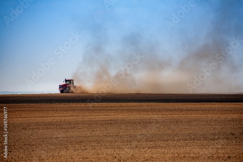 Tractor plowing the fields in spring © mironovm