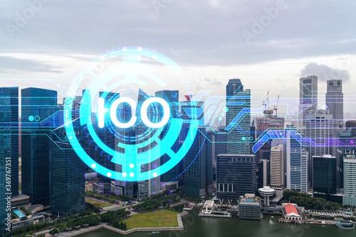 ICO icon hologram over panorama city view of Singapore, the hub of blockchain projects in Asia. The concept of initial coin offering. Double exposure.