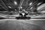 The man in a helmet in the go-kart moves on a karting track