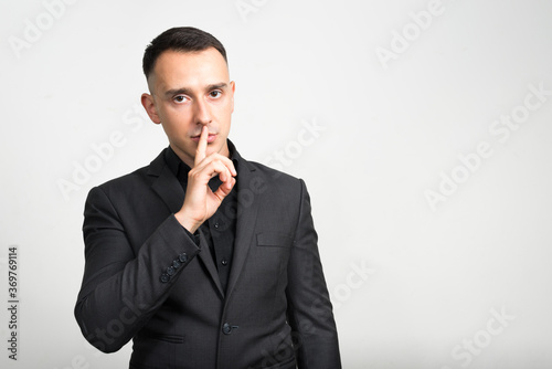 Portrait of handsome businessman in suit against white background