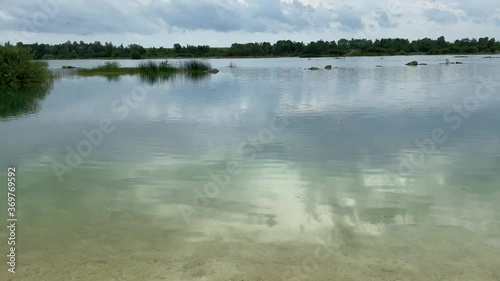 Old abandoned sand pit on a summer cloudy day photo