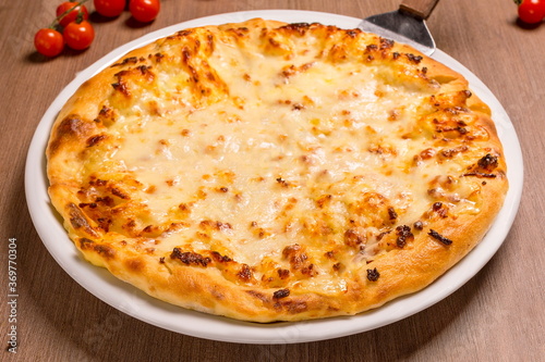 megrelian khachapuri Adyghe cheese, Suluguni, butter fork spoon salt photo