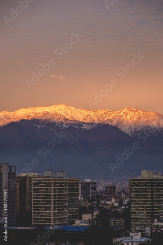 Amazing golden sunset sky over Santiago and Los Andes mountains with a ray of sunlight, Chile
