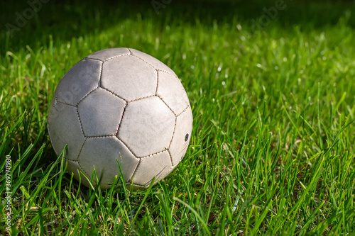 Football, sports. A fine green meadow with a soccer ball on it © 977_rex_977