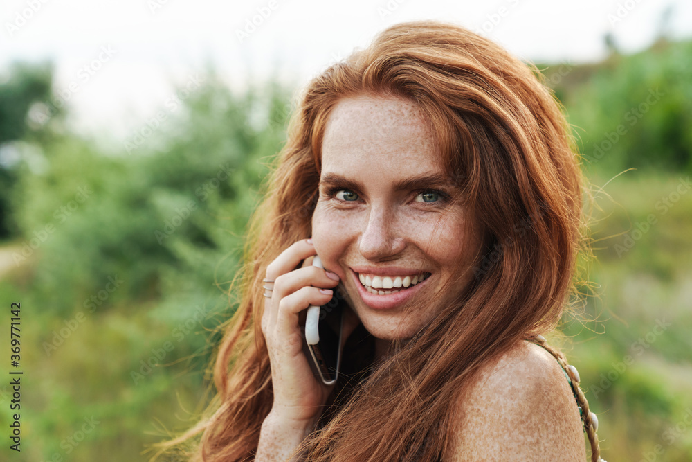 Young beautiful woman in summer dress talking Young beautiful woman in summer dress talking