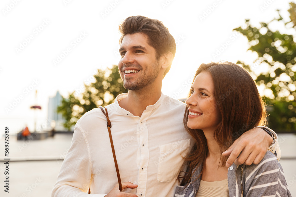 Fototapeta premium Happy beautiful couple walking in a city street