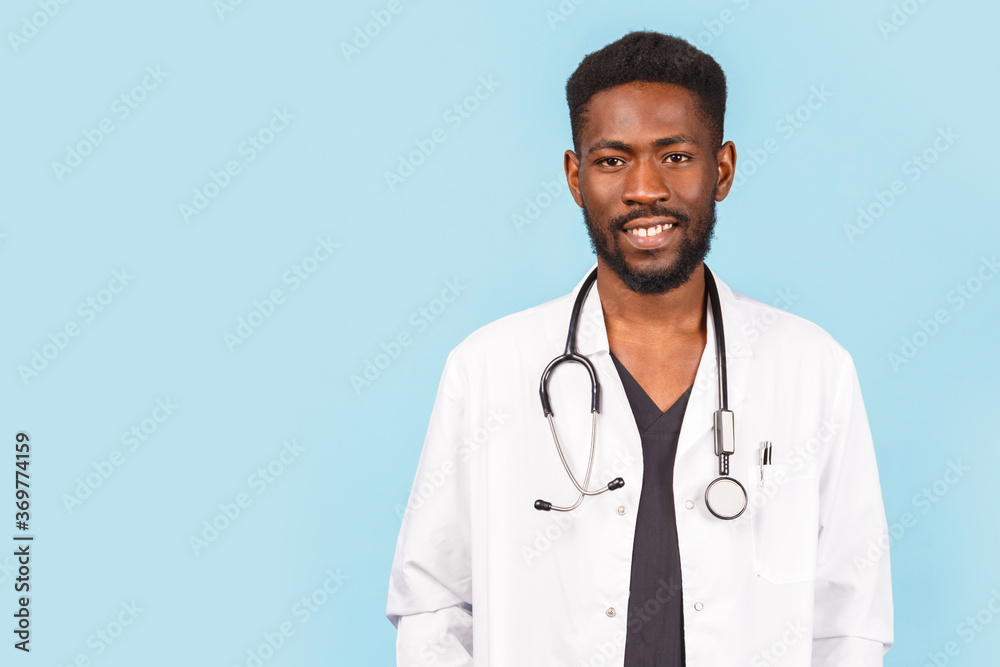medicine, profession and healthcare concept. African american male doctor with stethoscope in white coat on blue background medicine, profession and healthcare concept. African american male doctor with stethoscope in white coat on blue background