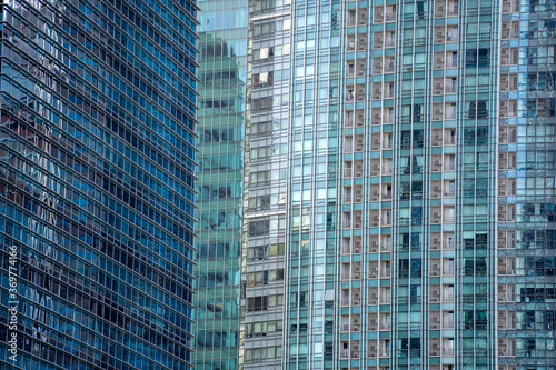 High glass skyscrapers on the streets of Singapore. Office windows background  closeup