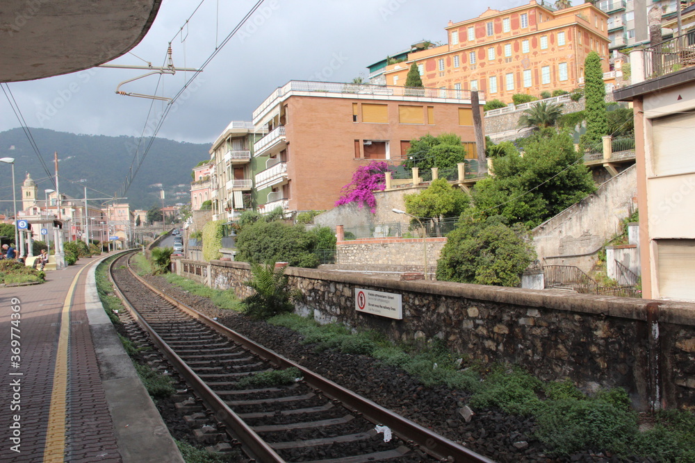 The railway stretches among picturesque Italian houses