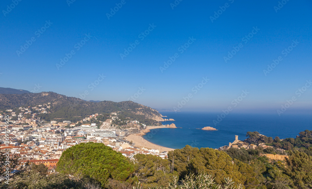Aerial panorama of scenic, sea landscape of Badia Bay coast on sunny day - Tossa de Mar, Catalonia, Spain.