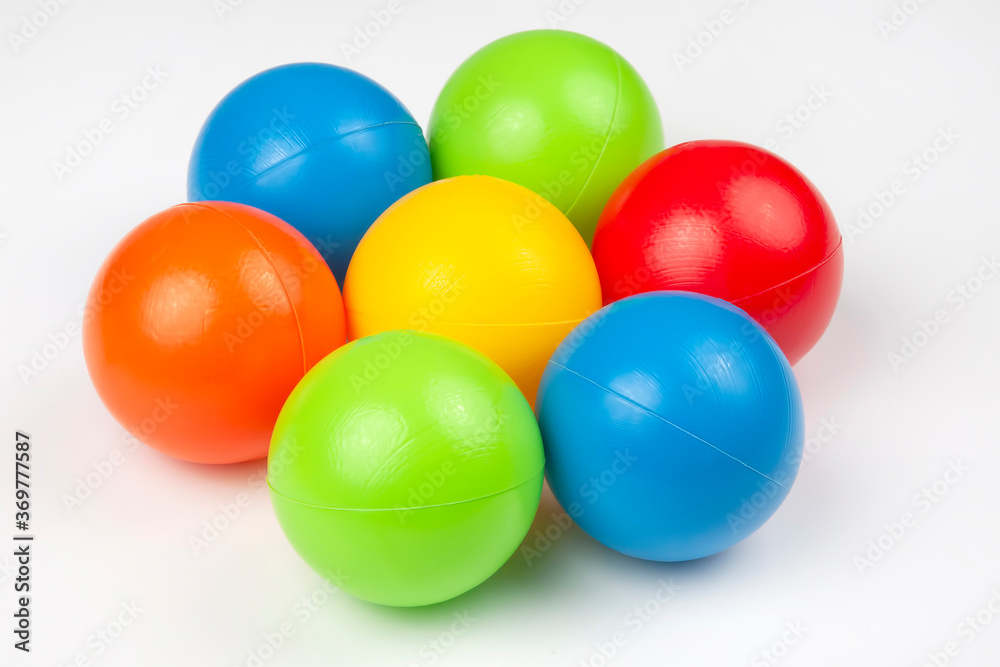 Colored plastic balls on white background