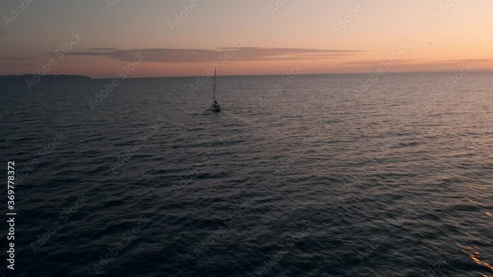 Sailing Boat In The Gulf Of Saint Lawrence With A Stunning Landscape Of Sky Reflecting On The Water Surface In Quebec, Canada. - aerial drone Sailing Boat In The Gulf Of Saint Lawrence With A Stunning Landscape Of Sky Reflecting On The Water Surface In Quebec, Canada. - aerial drone