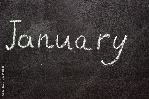 Month written in white chalk on a chalkboard. The month depicted on the chalkboard is January