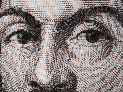 Caravaggio face on 100000 italian lire banknote extreme macro. photo