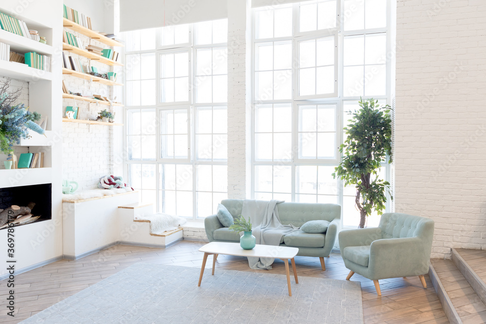 Fashionable spacious apartment with a stylish design in green, grey and white pastel colors with big window and decorative walls. bedroom and kitchen space Fashionable spacious apartment with a stylish design in green, grey and white pastel colors with big window and decorative walls. bedroom and kitchen space
