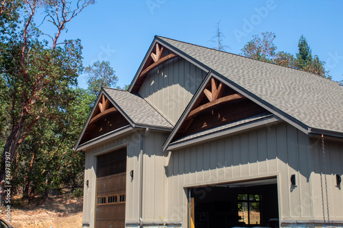 Tableau sur toile Large garage bays with arches and board and batten siding.